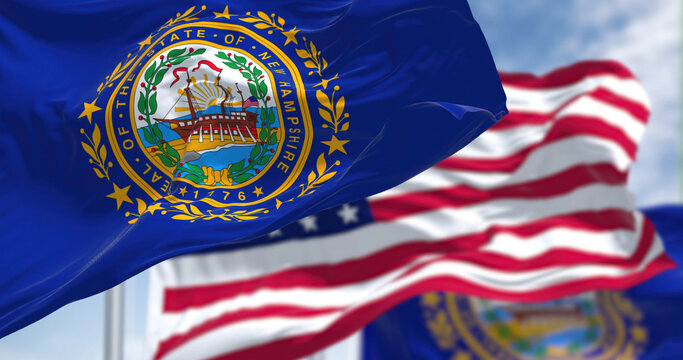 The New Hampshire state flag waving along with the national flag of the United States of America