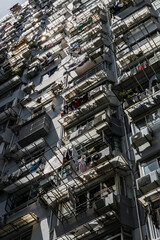 Residential building, looking up at balconies, clothes drying and sky with sunshine coming through