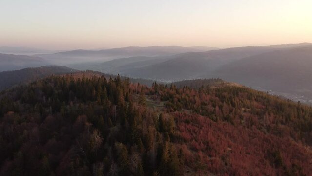 Sunrise over the Slovak countryside with a view near the town of Zborov nad Bystrica. Stone tower on the valley of Oravsk&aacute; magura. Morning orange soft light. Drone shot