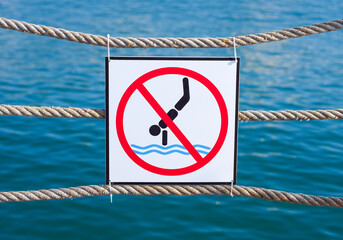 sign forbidding jumping into the water