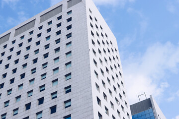 Fototapeta premium Genova, Italy-January 29, 2022: Beautiful modern high-rise buildings against the sky. 3d illustration on the theme of business success and technology. clouds reflection on the mirror.Industrial zone.