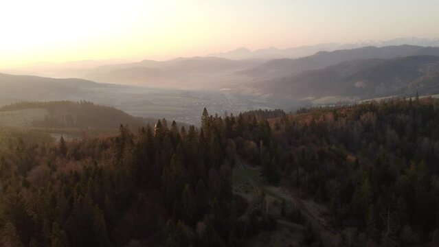 Sunrise over the Slovak countryside with a view near the town of Zborov nad Bystrica. Stone tower on the valley of Oravsk&aacute; magura. Morning orange soft light. Drone shot