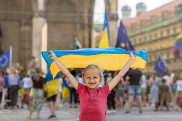 Anti War Protest. Support Ukrainian Children. Little Girl holding Ukrainian Flag on Rally Support...
