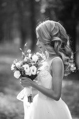 Black and white portrait of beautiful bride for a walk in the park.  Wedding day. Marriage. Fashion bride.