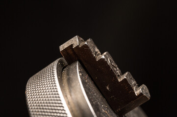 Assortment of steel machinists tooling for metalwork with gears, metal lathe chuck, macro close up...