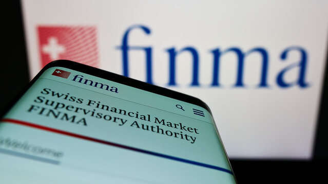 Stuttgart, Germany - 06-04-2022: Mobile phone with website of Swiss Eidgenossische Finanzmarktaufsicht (FINMA) on screen in front of logo. Focus on top-left of phone display.