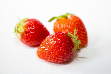 Strawberry fruit with strawberry leaf isolated on white background.