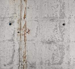smooth raw concrete wall with concrete form dimples, grid lines and brown rusty on its texture. cement stone texture background. gray concrete texture with dirty stripes along.