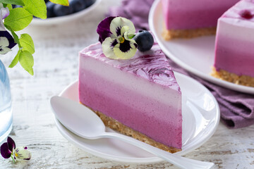 Piece of no baked blueberry layered cheesecake