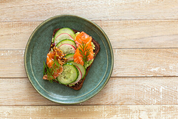 Smorrebrod, toast with rye bread, salmon, avocado