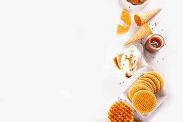 Fresh sweet ice cream with caramel sauce, waffles, cones. Summer food concept.