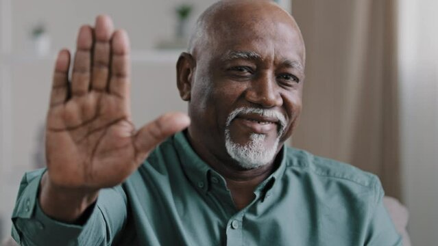 Serious strong old 60s senior mature African American ethnic male puts palm in front of him say no reject, confident elderly man show stop gesture demonstrate not never sign keep distance defends