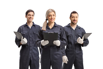 Female and two male workers in overall uniforms