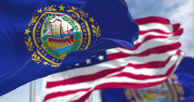 The New Hampshire state flag waving along with the national flag of the United States of America
