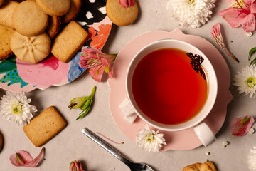 Butterfly pink tea cup and saucer with assorted butter cookies platter and flowers