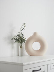 Simple and minimalist ornaments for home decor. Sandstone creamy colored vase with circular shape...