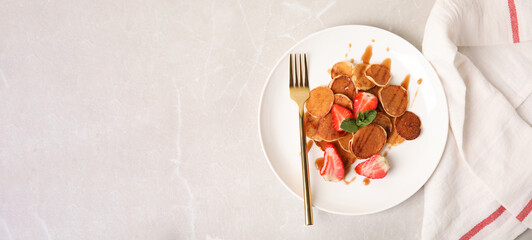 Cereal pancakes with strawberries on light grey marble table, flat lay with space for text. Banner design