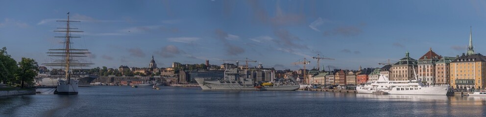 The bay Stockholms Ström with various boats, hostel af Chapman a full rigged sail ship, stem commuter boats and NATO warships visiting Stockholm a sunny summer day in Stockholm