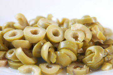  close up of slice of olives on white background 