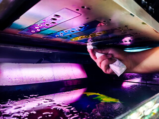 technician cleaning the print head