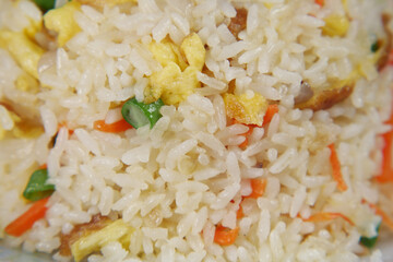 cooked fried rice in a bowl on table, close up,
