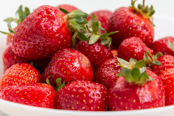 Fresh ripe strawberries. Background from strawberries. Close-up. Harvest strawberries. White background. Dessert.