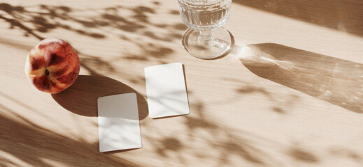 Blank paper sheet cards mockup and floral shadow top view on beige wooden background.Banner. Summer stationary template.Copy space. Flat lay minimal business brand template neutral color.Card mock up.