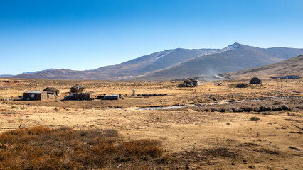 Traditional rural round huts in a Lesotho village in the countryside near Sani Pass road, Drakensberg