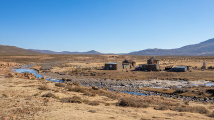 Traditional rural round huts in a Lesotho village in the countryside near Sani Pass road, Drakensberg