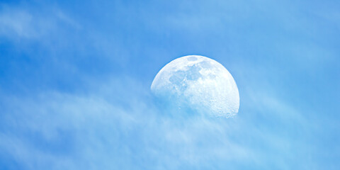 Naklejka na ściany i meble Moon seems to be floating on a Sea of Clouds. Blue clouds, Full Moon and White Clouds.