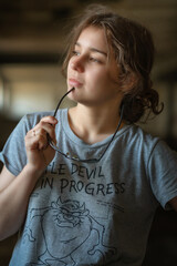 Portrait of a young beautiful girl in a dark studio. There is artistic noise.
