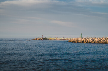 Fototapeta premium sea with cliff and 2 lighthouses at sunset