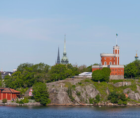 The cliff island Kastellholmen with a castle and towers in the background a sunny summer day in...