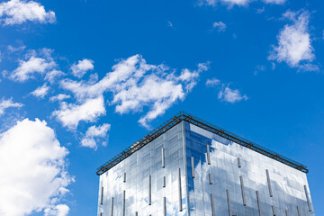 building with glass walls reflecting the sky