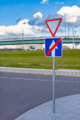 road sign forbidding straight ahead and requiring you to give way