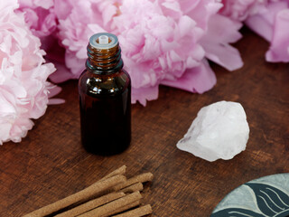 Floral essential oil with quartz rock crystal and natural organic incense sticks. Aromatherapy...