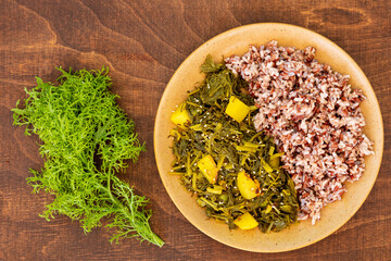 Mustard green with potato (Sarson Saag) traditional Indian cuisine dish with rice.