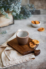 Kitchen still life with empty tea or coffee cup on board and towel
