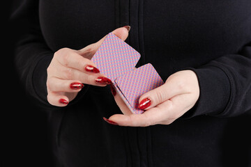 Female hands hold a deck of cards and show tricks.
The photographer is the author of the design of...