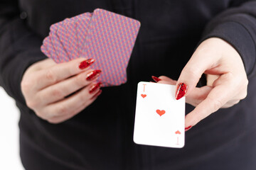 Female hands hold a deck of cards and show tricks.
The photographer is the author of the design of...