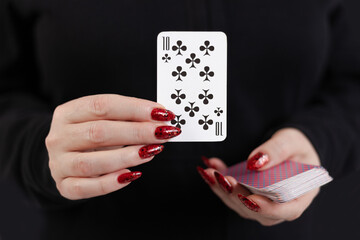 Female hands hold a deck of cards and show tricks.
The photographer is the author of the design of...