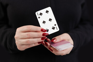 Female hands hold a deck of cards and show tricks.
The photographer is the author of the design of...