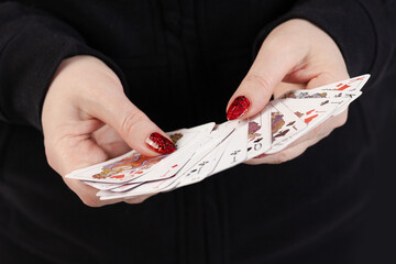 Female hands hold a deck of cards and show tricks.
The photographer is the author of the design of...
