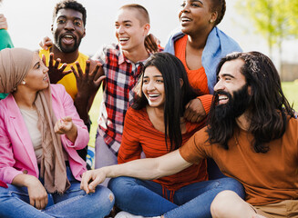 Group of happy multiracial people enjoy day at city park