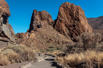 Walking path in Teide National Park with rock formations in the background. Volcanic landscape....