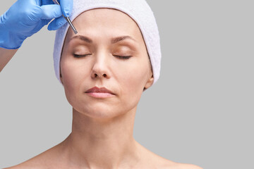 Beautician skin care. Face tweezers. Facial treatment. Woman dermatology. Salon routine. Applying...