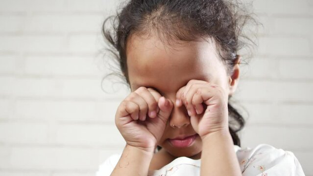 a upset child girl looking down 