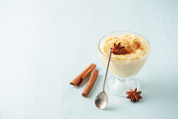 Curau de Milho (Brazilian Corn Pudding). Traditional Brazilian dessert. Corn porridge with cinnamon in a bowl.