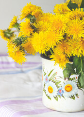 Yellow dandelions in a rustic vase - 509867053