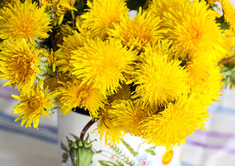 Yellow dandelions in a rustic vase - 509867071